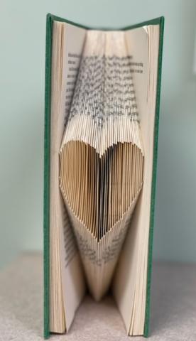 A heart shape made by folding book pages. 